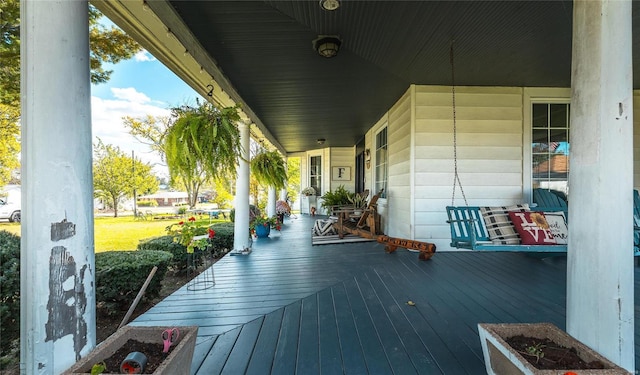 wooden terrace featuring covered porch