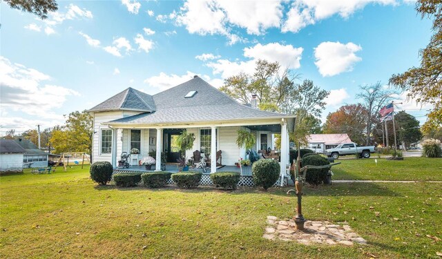 view of front of home with covered porch and a front lawn