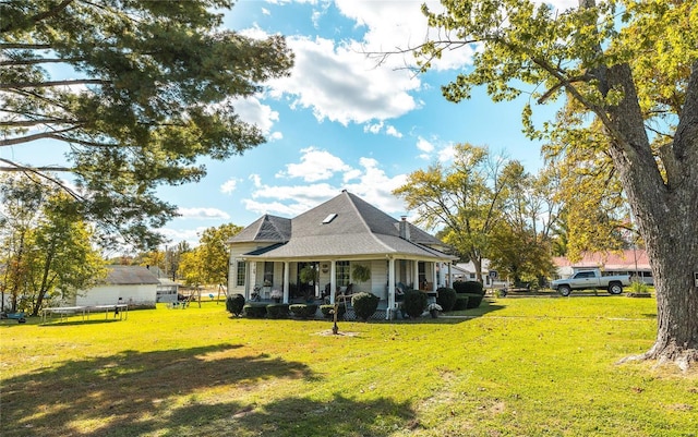 exterior space with a trampoline, a yard, and covered porch