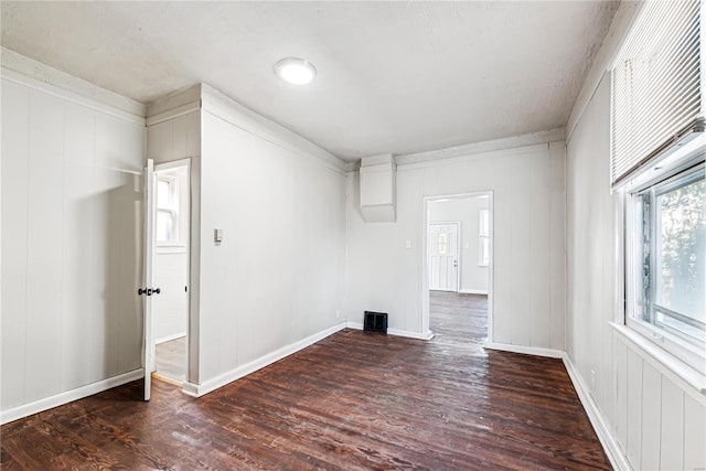 unfurnished room with dark hardwood / wood-style floors