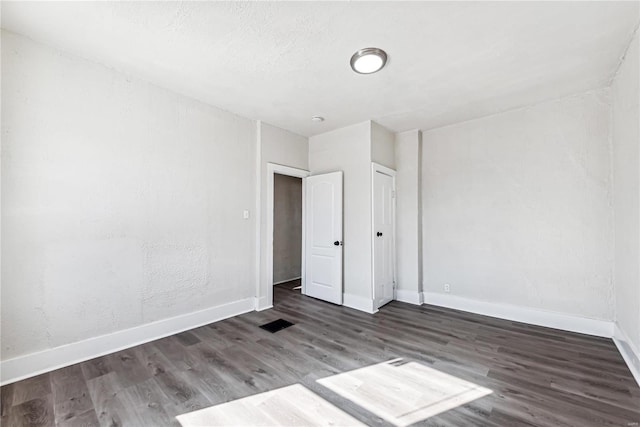 empty room featuring dark hardwood / wood-style floors