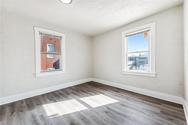 unfurnished room with hardwood / wood-style flooring