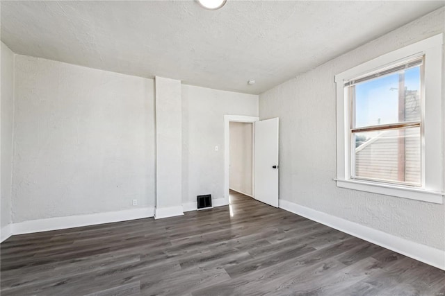 empty room featuring dark wood-type flooring