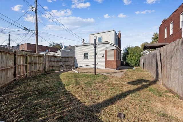 rear view of property with a patio and a lawn