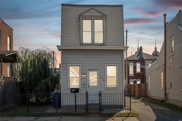 view of back house at dusk