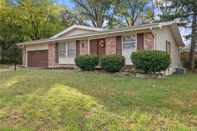 ranch-style home with cooling unit, a front lawn, and a garage