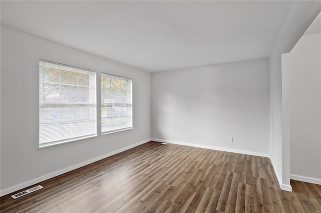 spare room with hardwood / wood-style flooring