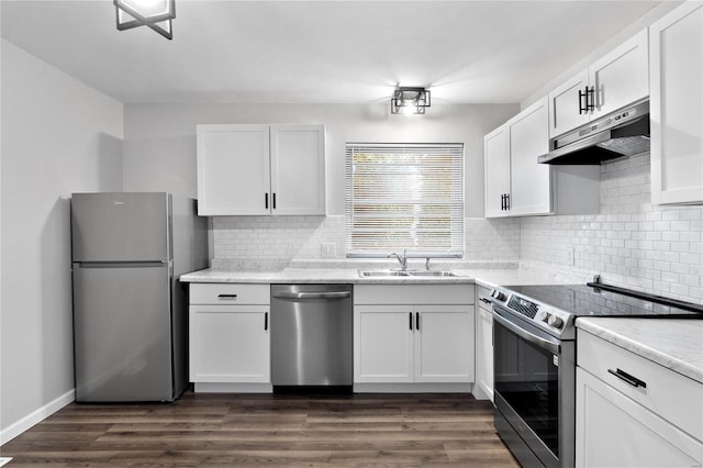 kitchen featuring appliances with stainless steel finishes, white cabinets, sink, and dark wood-type flooring