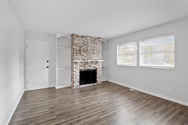 unfurnished living room with dark hardwood / wood-style floors and a fireplace