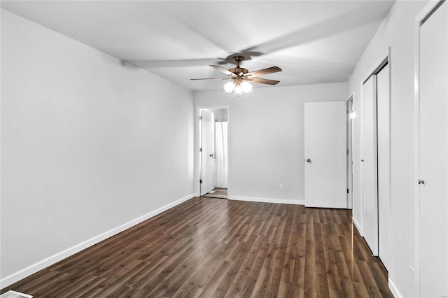 unfurnished bedroom featuring dark hardwood / wood-style floors and ceiling fan