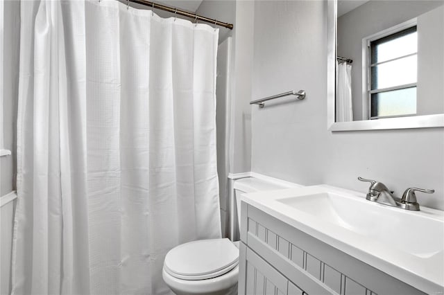 bathroom with vanity, toilet, and a shower with curtain