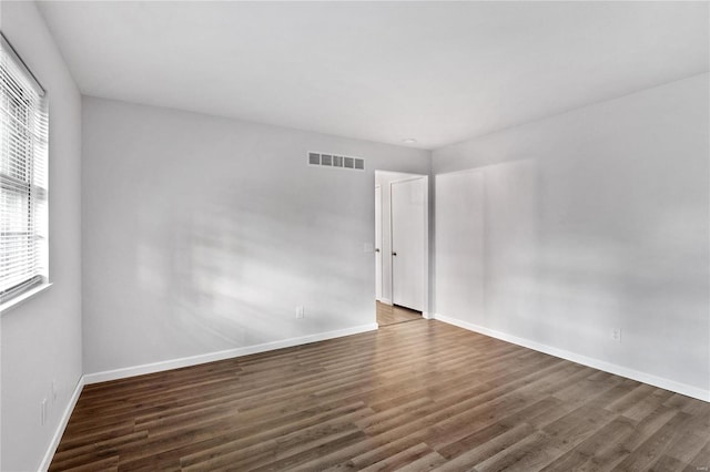 empty room featuring dark hardwood / wood-style flooring