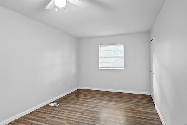 unfurnished room with dark hardwood / wood-style floors and ceiling fan