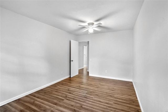 empty room featuring ceiling fan and dark hardwood / wood-style floors