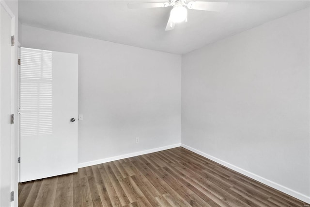 spare room featuring ceiling fan and dark hardwood / wood-style flooring