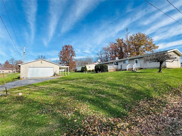 view of yard with a garage and an outdoor structure