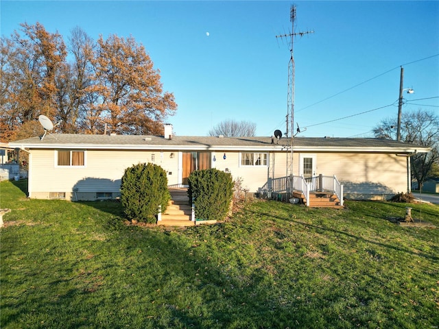 rear view of property with a lawn