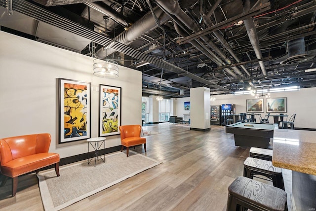 game room with wood-type flooring and billiards