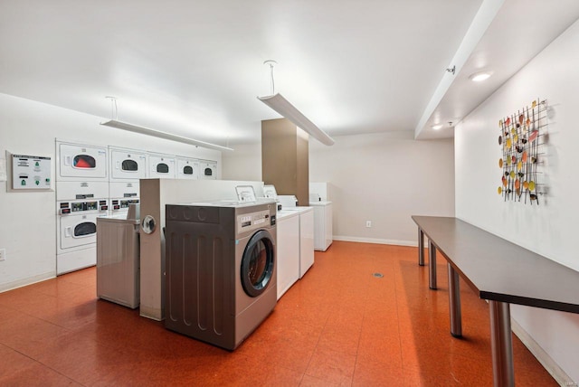 laundry room with washing machine and dryer and stacked washer / dryer