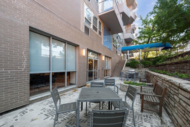 view of patio featuring a balcony