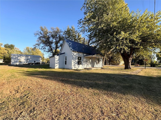 view of home's exterior with a yard and metal roof