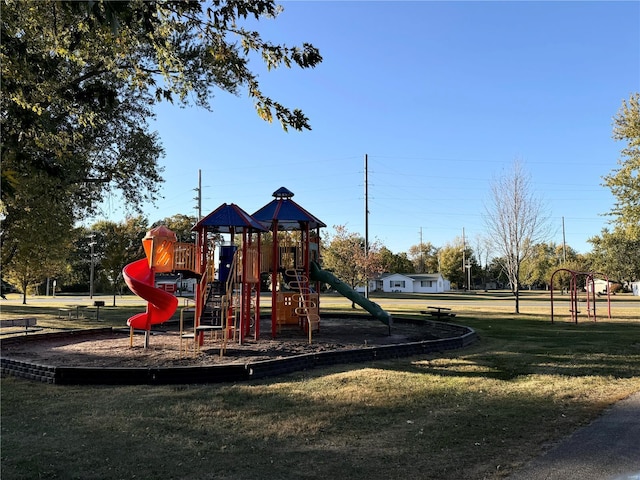 community jungle gym featuring a lawn