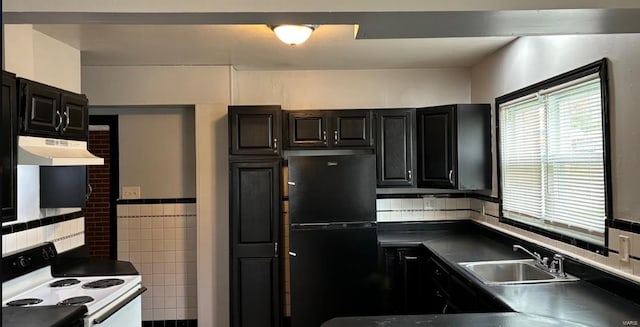 kitchen featuring decorative backsplash, white electric stove, sink, and black fridge