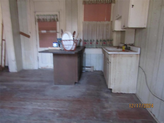 kitchen featuring white cabinets and sink