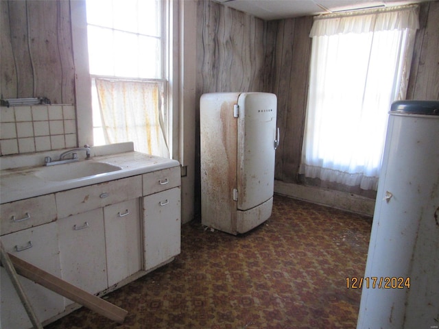 kitchen featuring white cabinets and sink