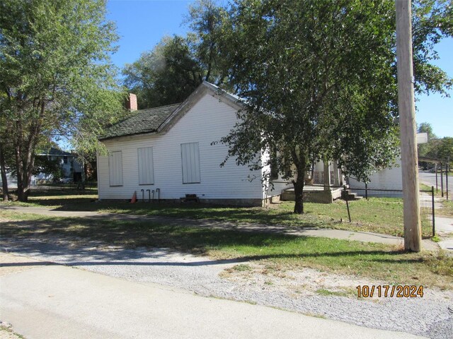 view of side of home with a lawn