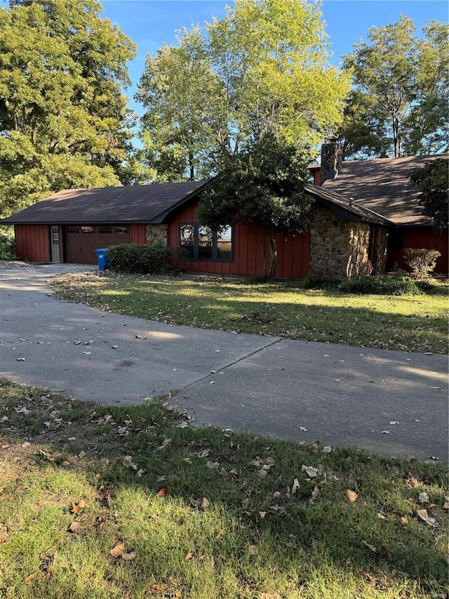 view of home's exterior featuring a garage and a lawn