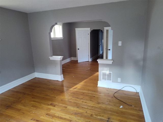 empty room with hardwood / wood-style floors