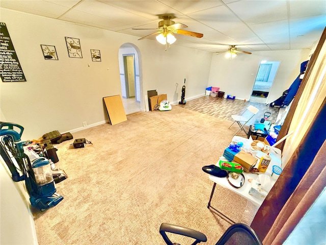 rec room featuring ceiling fan, carpet, and a paneled ceiling