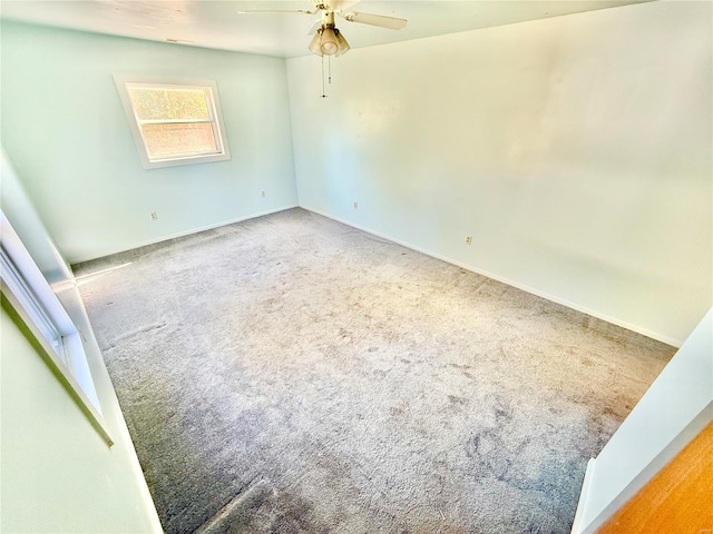 empty room with carpet flooring and ceiling fan