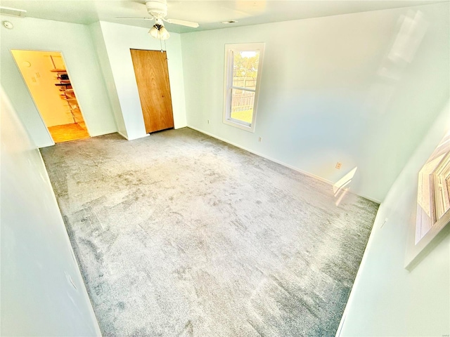 unfurnished room with ceiling fan and light colored carpet