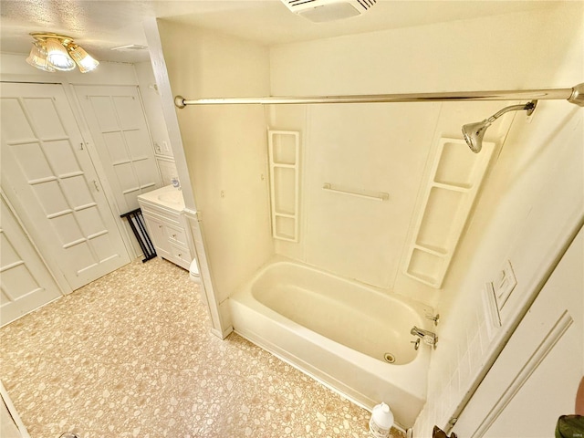 bathroom with vanity, a textured ceiling, and shower / bath combination