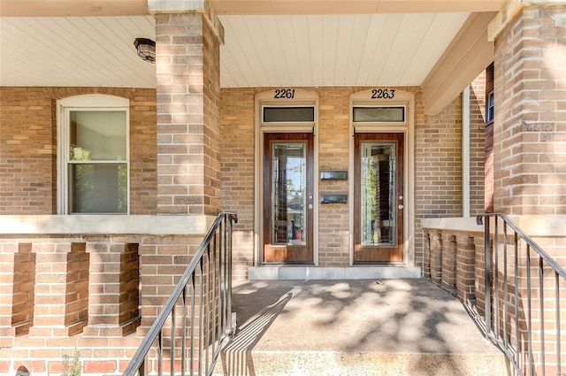 view of exterior entry featuring covered porch