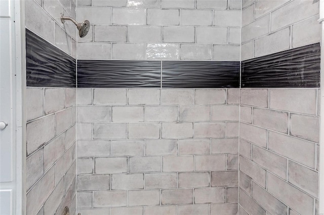 interior details with a tile shower