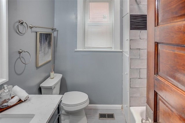 bathroom with tile patterned floors, a bathtub, vanity, and toilet