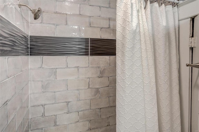 interior details featuring a shower with shower curtain