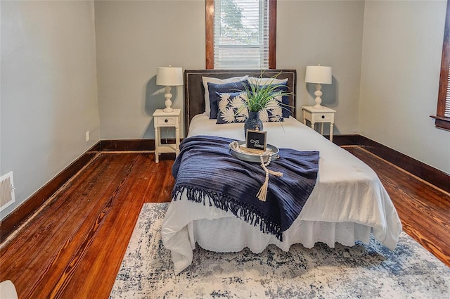 bedroom with dark wood-type flooring