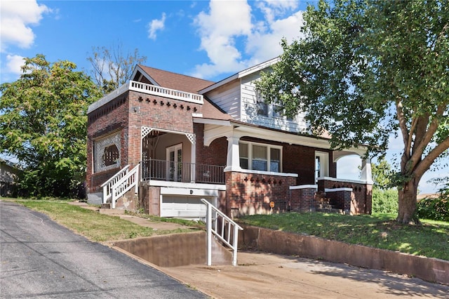 view of front of property featuring a garage and a porch