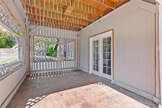 unfurnished sunroom with a wealth of natural light and french doors