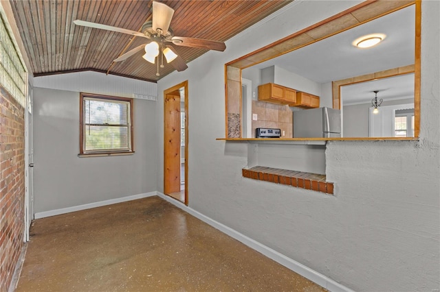 unfurnished room with wood ceiling, ceiling fan, concrete floors, and vaulted ceiling