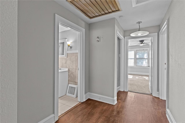 corridor with hardwood / wood-style floors