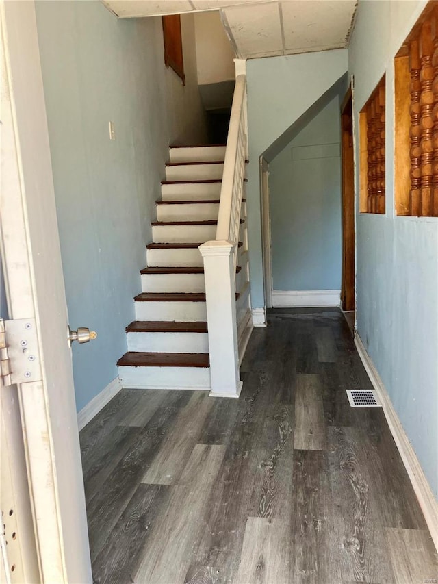 stairs with hardwood / wood-style flooring