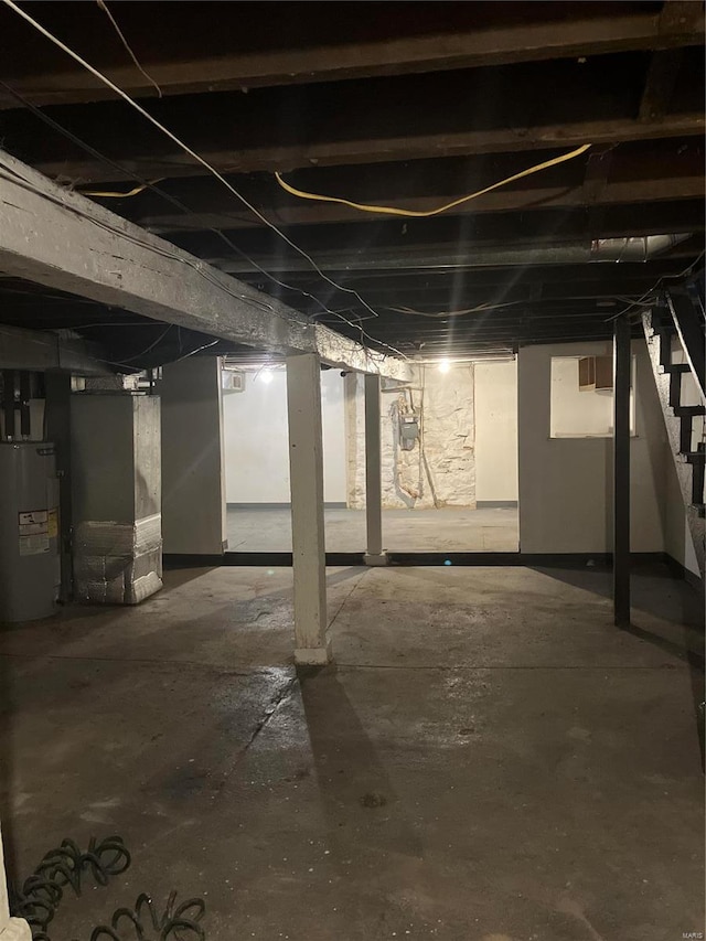 basement featuring heating unit and water heater