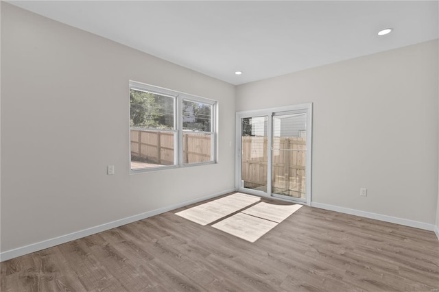 spare room featuring light hardwood / wood-style floors