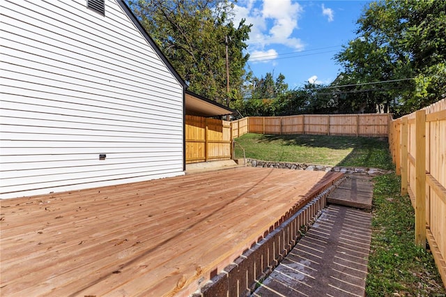 wooden deck featuring a yard