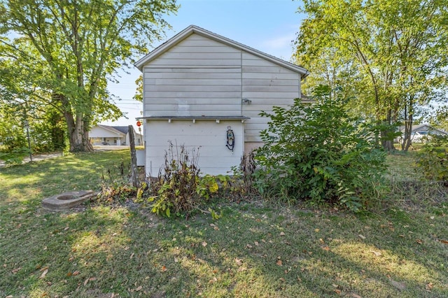 view of side of home featuring a lawn